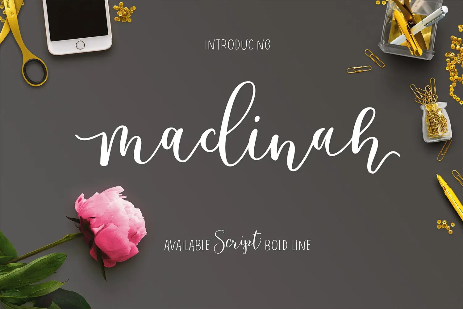 Top 9 Best Romantic Script Fonts for Valentine’s Day Cards 9 Madinah Script Font displayed with a pink peony and stationery items on a dark background.