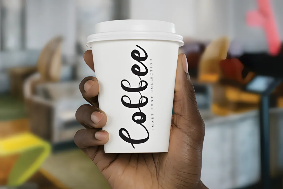 15 Best Script Fonts for Formal and Casual Branding 13 A hand holding a coffee cup featuring the script font 'Coffee' in a stylish design.