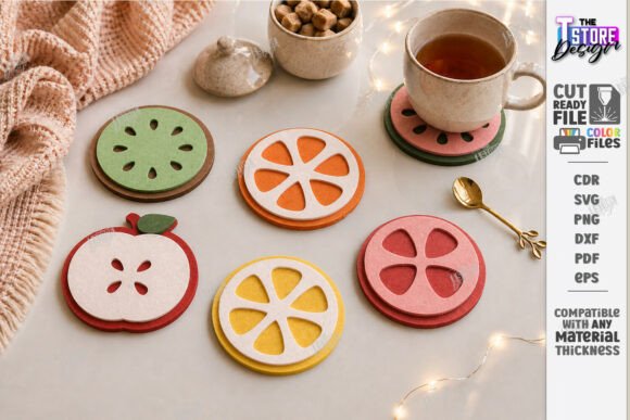 Easy Laser Cut Wood Projects To Sell On Etsy 13 Colorful laser cut wood coasters shaped like fruits, including apple, orange, and lemon, arranged on a table.