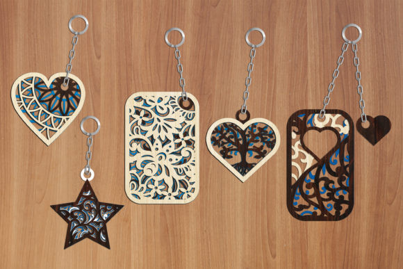 99+ Laser Cut Wood Projects To Sell From Home 56 Colorful laser cut wood keychains in various shapes including hearts and stars on a wooden background.