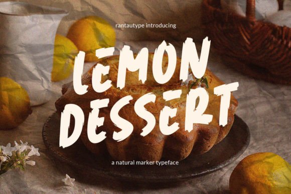 70+ Food Logo Fonts for Restaurants, Cafes, and Food Brands 159 Lemon Dessert font displayed on a cake with lemons in the background.