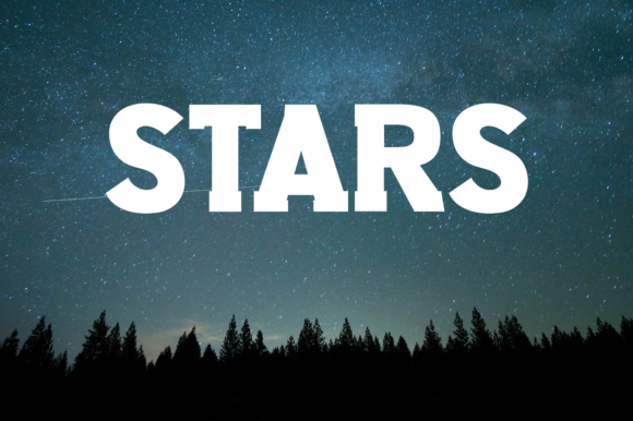 Fonts Similar to Clarendon: 15 Powerful Alternatives 15 The word 'STARS' in bold slab serif font against a starry night sky.