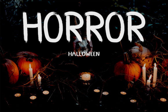 Halloween Color Fonts: 10 Best Picks for Spooky Designs 14 The word 'HORROR' in a spooky font surrounded by pumpkins and candles.