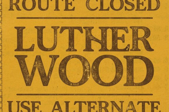 18 Best Slab Serif Display Fonts for Bold Headlines 14 Bold slab serif font displaying 'Lutherwood' on a closed route sign.