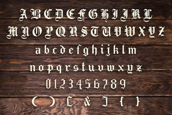 16 Gothic Fonts for Halloween Invitations That Look Stunning 3 Gothic font sample showcasing uppercase and lowercase letters, numbers, and symbols on a wooden background.