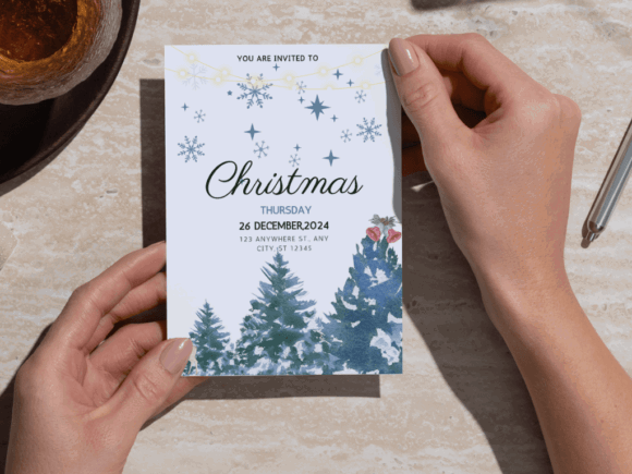 Christmas Party Invitation Templates: 35 Festive Picks 4 A hands holding a Christmas party invitation featuring snowy trees and festive decorations.