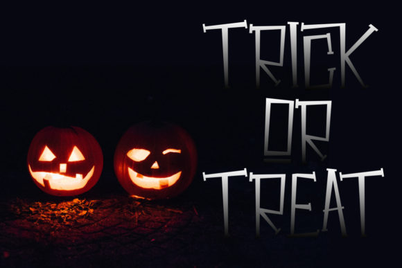 28 Halloween Fonts for Stickers & Labels That Print Clearly 5 Two carved pumpkins with a spooky 'Trick or Treat' text beside them.